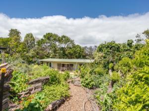 a house in the middle of a garden at Summer In Blairgowrie in Blairgowrie