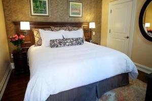 a bedroom with a large white bed in a room at Norwalk Inn & Conference Center in Norwalk