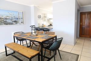 a dining room with a table and chairs at Langebaan Golf Lagoon Haven in Langebaan