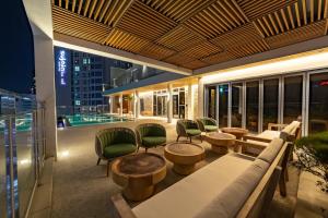a patio with tables and chairs and a pool at Hound Hotel Haeundae Signature in Busan