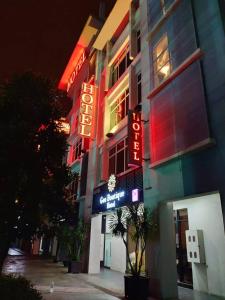 a building with neon signs on the side of it at Geo Boutique Hotel - Seri Kembangan in Seri Kembangan