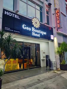 a cisco boutique hotel with a sign in front of it at Geo Boutique Hotel - Seri Kembangan in Seri Kembangan