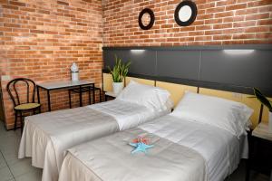Postel nebo postele na pokoji v ubytování Hotel Marina