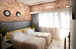 Postel nebo postele na pokoji v ubytování Hotel Marina