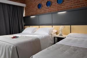 Postel nebo postele na pokoji v ubytování Hotel Marina