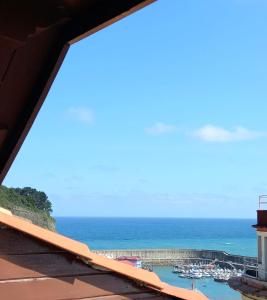 a view from a balcony of a building with a view of the ocean at Hotel Eutimio in Lastres