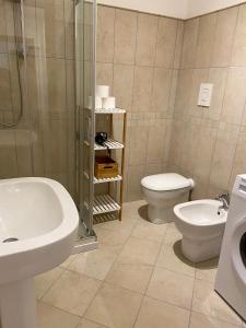 a bathroom with a sink and a toilet and a shower at Ada's House in Alghero