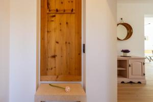 a wooden door in a room with a bench at Residence Villa Schlern in Fiè +51 photos