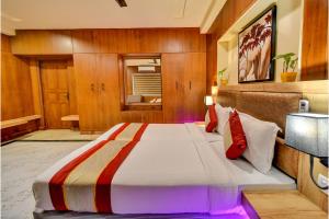 a hotel room with a bed, table, and television at FabHotel Nestlay Rooms Airport in Chennai
