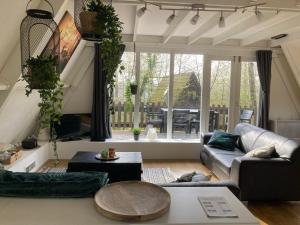 a living room with a couch and a table at Chalet 42 - Durbuy in Durbuy
