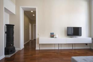 a living room with a tv on a white table at White Door Apartments in Odesa