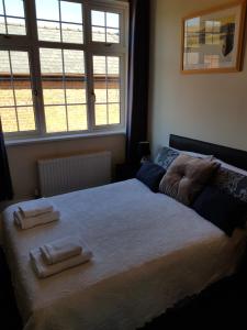 a bedroom with a large bed with two towels on it at The Chase Inn in Bishops Frome