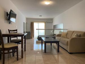 a living room with a couch and a table at Alexia Hotel Apartments in Ayia Napa