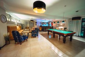 a living room with a pool table in it at BM Plaza in Bakuriani