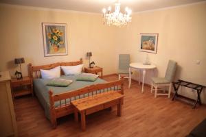 a bedroom with a bed and a table and chairs at Seewirt Ecking in Riedering