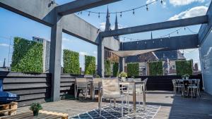 
an outdoor dining area with tables, chairs and umbrellas at Design Hotel Glow in Eindhoven
