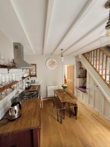 a kitchen with a wooden table and a counter top at Charming 2-Bed Cottage on outskirts of Beverley in Beverley