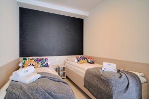 Łóżko lub łóżka w pokoju w obiekcie Apartamenty Na Klifie