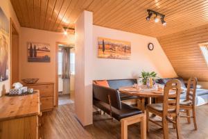 a dining room with a table and chairs at Ferienhof Dachsberg Weitblick in Bermatingen