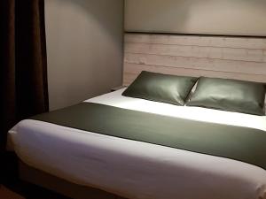 a bedroom with a large bed with at L'Usine in Belval