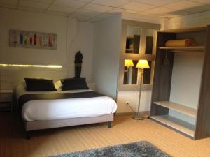 a bedroom with a bed and a lamp in it at L'usine in Belval