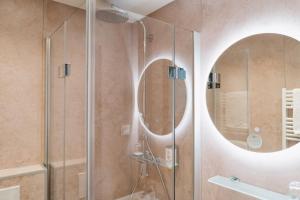 a bathroom with a shower and a large mirror at Hotel Stümpelstal in Marburg an der Lahn