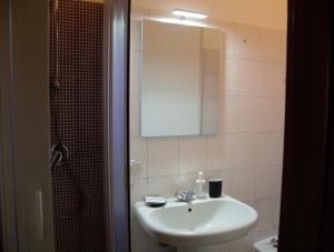 a bathroom with a sink and a mirror and a shower at Civico 107 in Grottaminarda