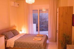 a bedroom with a bed with two towels on it at Nikoletta's Studio 2 in Komotini