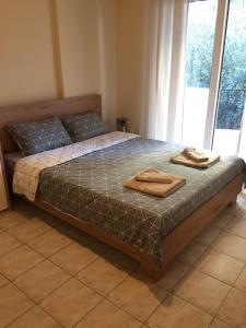 a bedroom with a bed with two towels on it at Nikoletta's Studio 2 in Komotini