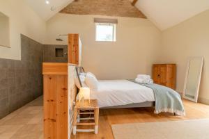a small bedroom with a bed and a shower at Bull Pen in Dyrham