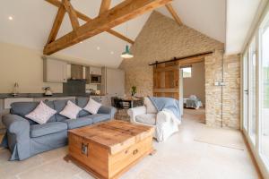 a living room with a couch and a table at Bull Pen in Dyrham