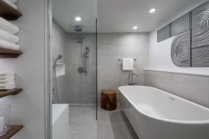 a white bathroom with a tub and a shower at Hyatt Regency Boston Harbor in Boston