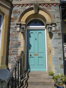 a blue door leading to a large brick building at Fitz House in Keswick