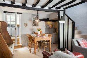 a kitchen and dining room with a table and chairs at Millers Cottage in Chipping Campden