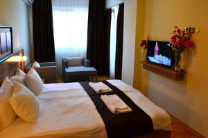 a hotel room with a bed with two towels on it at Park Lakeside Ohrid in Ohrid