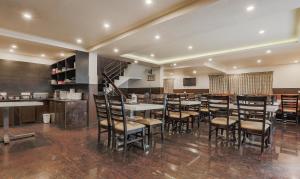 a restaurant with tables and chairs in a room at The Baron in Ooty