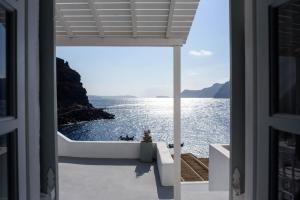 a view of the ocean from the balcony of a house at Amoudi Villas in Oia