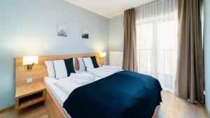 Posteľ alebo postele v izbe v ubytovaní Apartamenty Sun & Snow Resort Karkonosze
