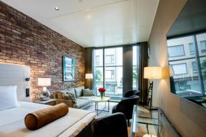 a hotel room with a bed and a brick wall at Solo Sokos Hotel Lahden Seurahuone in Lahti +51 photos