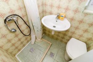 a bathroom with a sink and a toilet and a shower at Rooms Jozomare in Dubrovnik