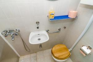 a small bathroom with a toilet and a sink at Rooms Jozomare in Dubrovnik