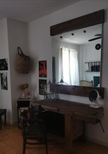 a mirror in a living room with a wooden table at B&B LaMaGia di Corte Moronati in Sirmione