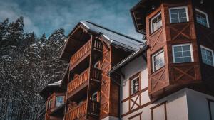 a building with wooden balconies on the side of it at Wellness Penzión Smerdžonka - KÚPELE PIENINY in Červený Kláštor +28 photos