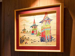a framed picture of a painting of a castle at Comfort Hotel Kyoto Horikawagojo in Kyoto