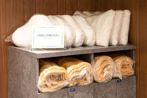 a shelf filled with lots of bags of bread at Comfort Hotel Kyoto Horikawagojo in Kyoto