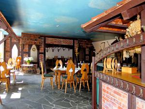 a restaurant with tables and chairs in a room at Burg Hotel Ziesar in Ziesar