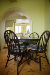 a dining room table with two chairs and a table with a mirror at Apartment Slađana in Subotica