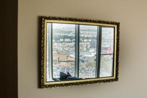 a mirror hanging on a wall next to a window at Panoramic View in Swansea