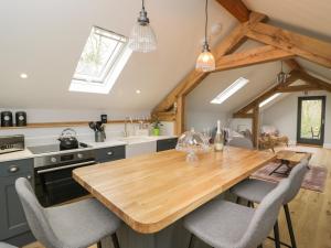 a kitchen with a wooden table and chairs at Lugg View in Hereford