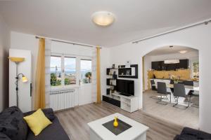 a living room with a couch and a table at Apartment Pepi in Lovran